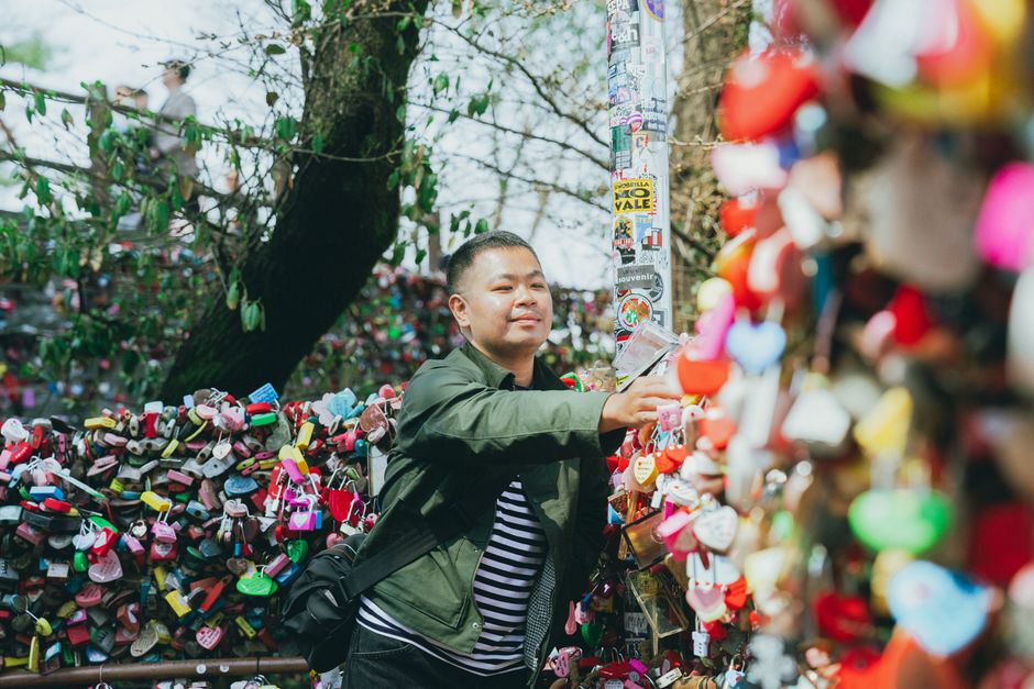 A visitor places a lock on the famous love lock fence at Namsan Tower in Seoul.