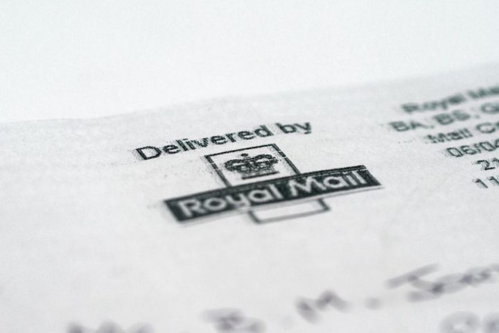 Macro shot of a Royal Mail stamp on a document highlighting postal delivery.