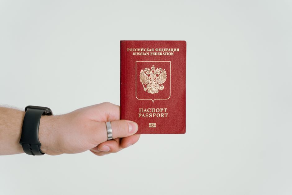 Close-up of a hand holding a Russian Federation passport.