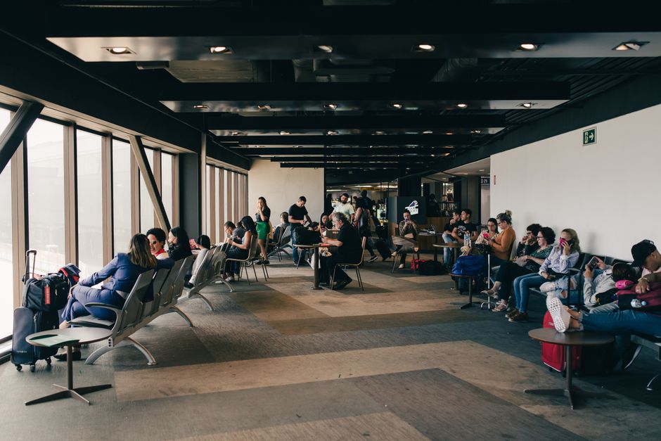 Passengers relaxing in a São Paulo airport waiting area, capturing a travel moment.